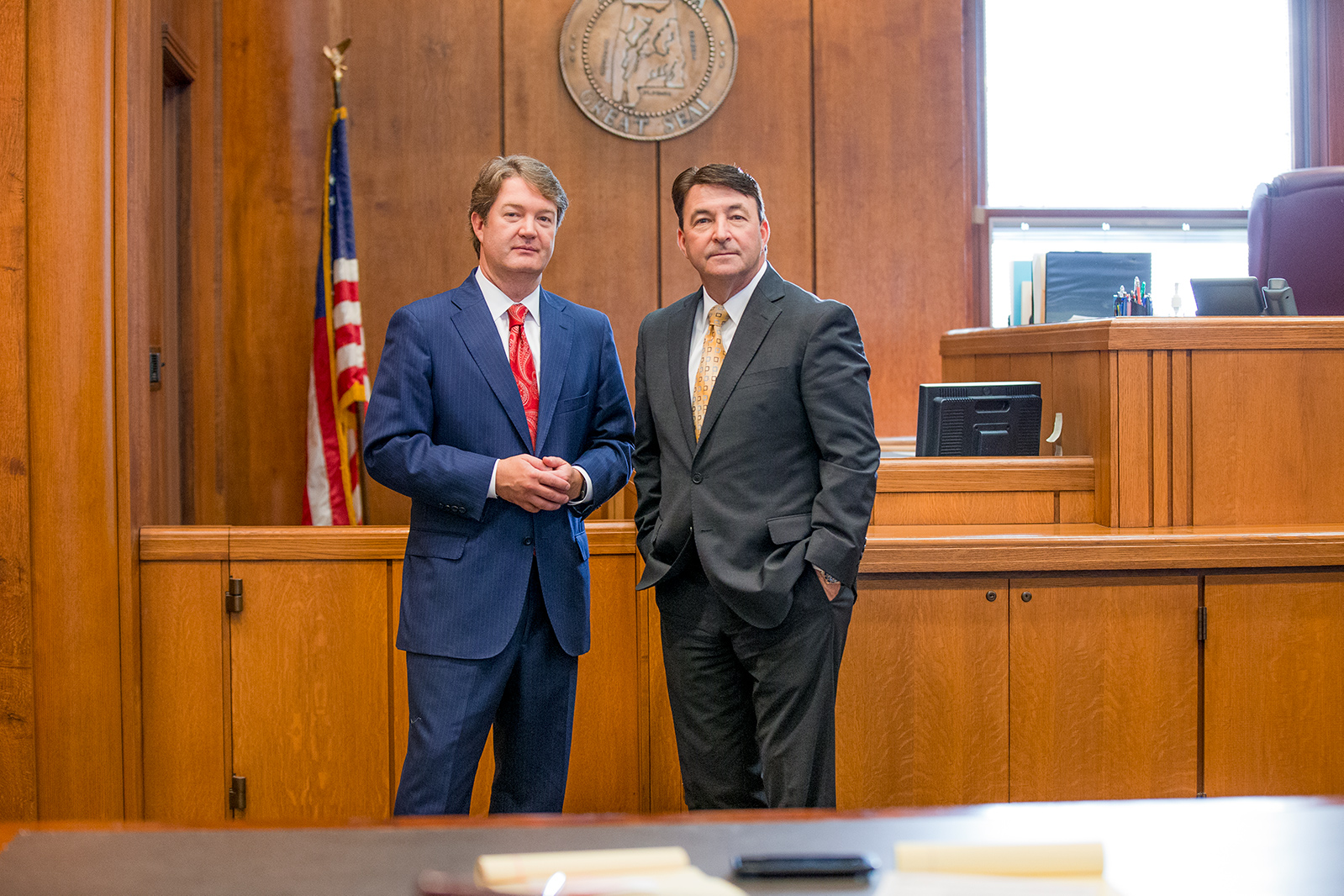 ken riley and kirby farris personal injury lawyers in birmingham alabama standing next to each other in a court room