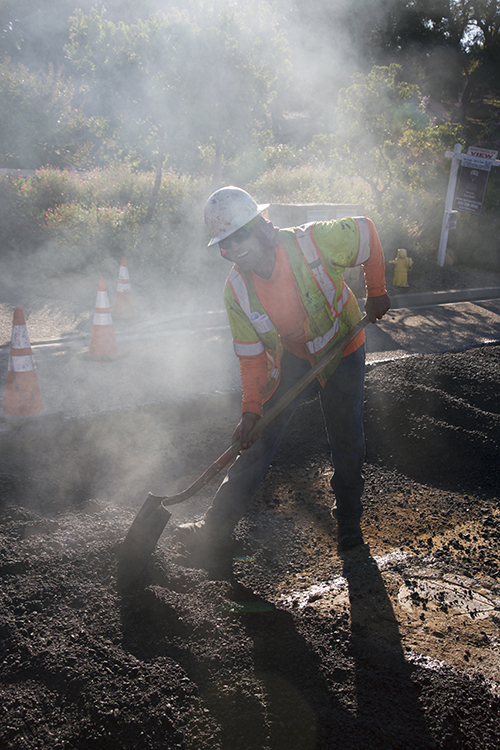 Workman on the road w/ shovel
