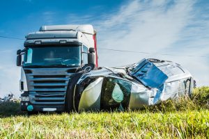 semi turns car on its side
